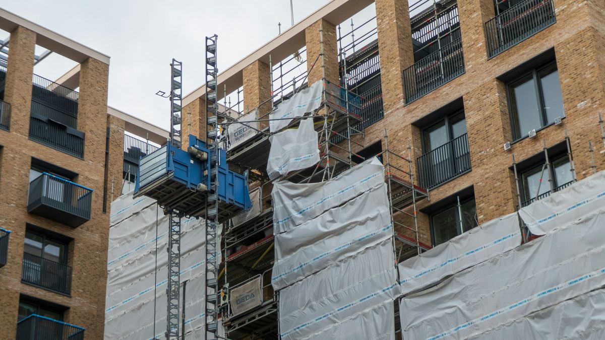 Multi-story building with scaffolding and a construction hoist