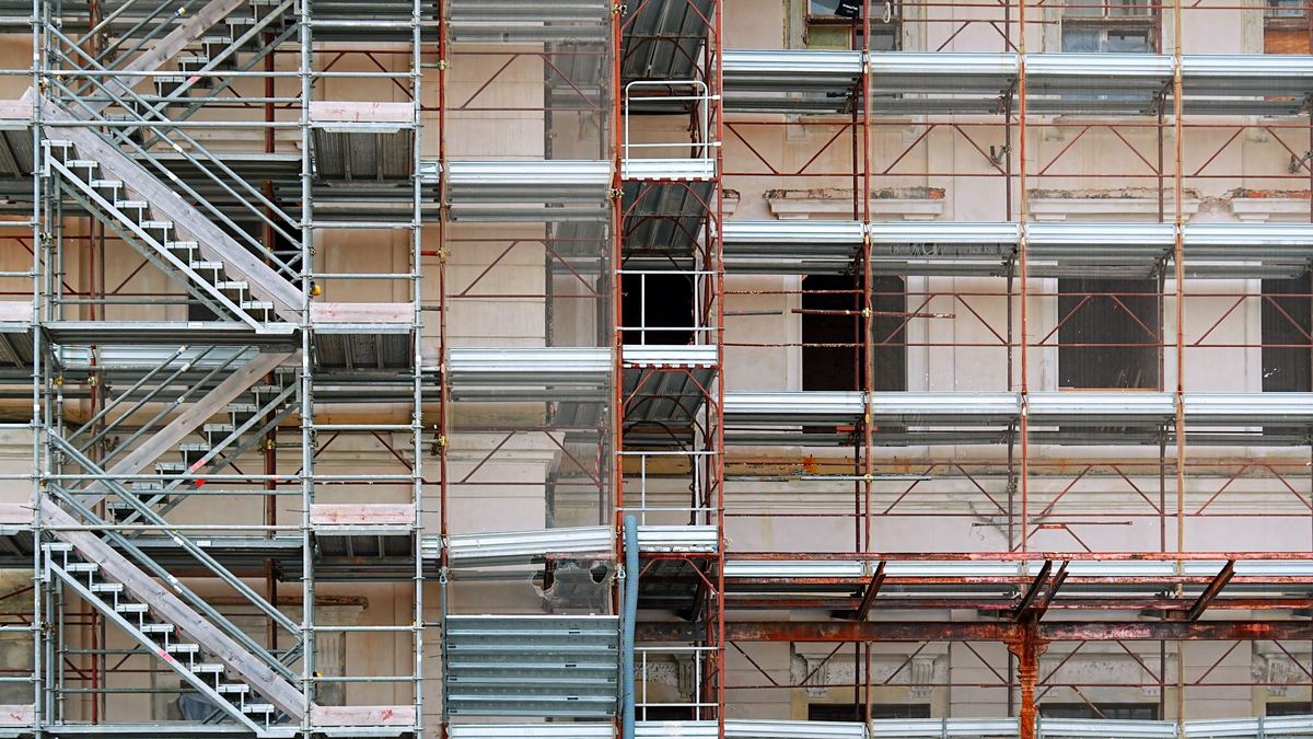 Scaffolding and stair towers along the facade of a building under construction