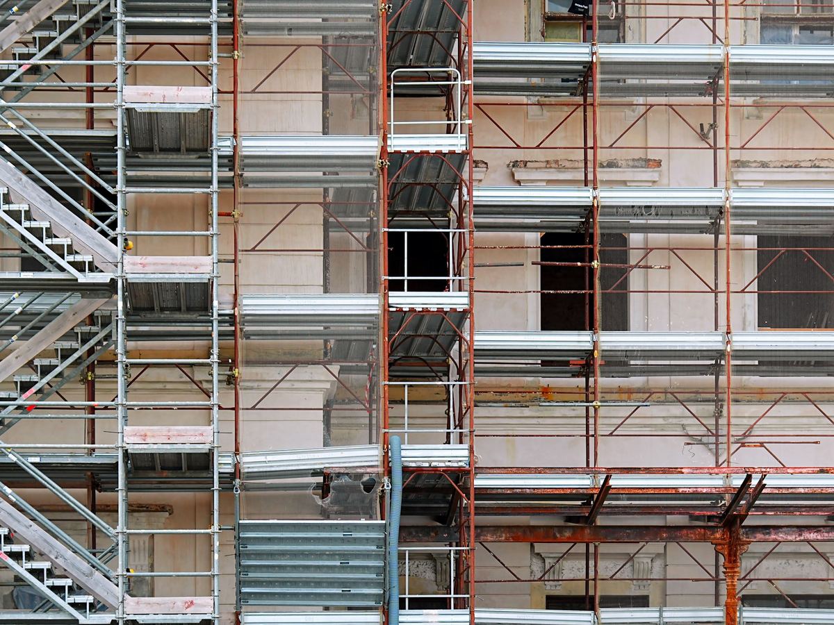 New building structure with scaffolding and stair towers
