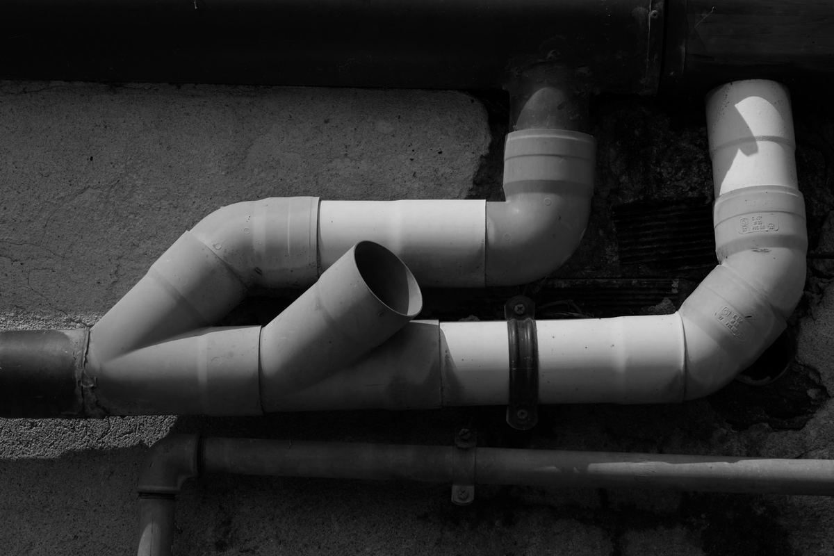 Drain and vent piping routed along a wall